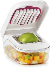 Load image into Gallery viewer, OXO Good Grips Vegetable Chopper with Easy Pour Feature - White, in use.