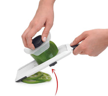 Load image into Gallery viewer, OXO Good Grips Adjustable Handheld Mandoline Slicer - White, in use.