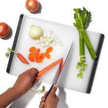 Load image into Gallery viewer, Lifestyle image of OXO Good Grips Utility Cutting Board - 26.75 x 37cm, Translucent White.
