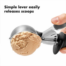 Load image into Gallery viewer, OXO Good Grips Trigger Ice Cream Scoops - Black, in use with ice cream scoop.