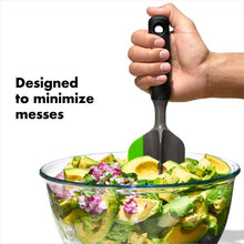 Load image into Gallery viewer, OXO Good Grips Scoop and Smash Avocado Tool - Dark Grey, in use.