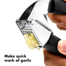 Load image into Gallery viewer, OXO Good Grips Garlic Press - Black, in use.