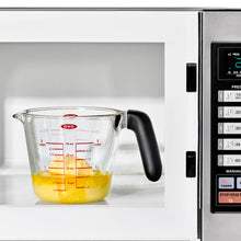 Load image into Gallery viewer, Lifestyle image of OXO Good Grips Glass Measuring Cup with Lid - 500ml.