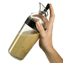 Load image into Gallery viewer, OXO Good Grips Salad Dressing Shaker - Available in 2 Sizes, Black, in use.