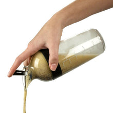 Load image into Gallery viewer, OXO Good Grips Salad Dressing Shaker - Available in 2 Sizes, Black, filled, in use.