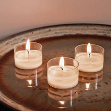 Load image into Gallery viewer, Lifestyle image of Bolsius Pack of 24 Tealight Candles, 6-hour Burn Time - Clear Cup.