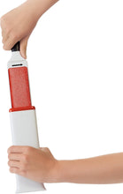 Load image into Gallery viewer, OXO Good Grips FurLifter Furniture Brush - Grey / Red, in use.