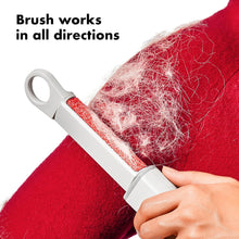 Load image into Gallery viewer, OXO Good Grips Reusable Lint Roller - Grey/ Red, in use.