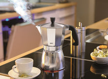 Load image into Gallery viewer, Lifestyle image of Gefu Lucino Espresso Maker - 3 cups or 6 cups, Stainless Steel.
