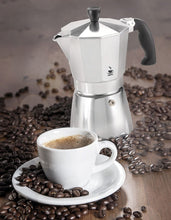 Load image into Gallery viewer, Lifestyle image of Gefu Lucino Espresso Maker - 3 cups or 6 cups, Stainless Steel with coffee cup.