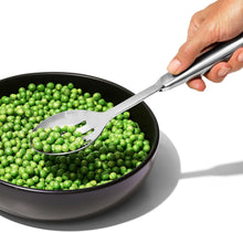 Load image into Gallery viewer, OXO Good Grips Slotted Serving Spoon - Stainless Steel, in use.