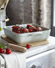 Load image into Gallery viewer, Lifestyle image of Emile Henry Square Oven Baking Dishes - 28 x 28cm - White.