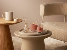Load image into Gallery viewer, Lifestyle image of Bolsius True Scents Fragranced Candle in Glass - 80/73mm, Peach.