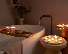 Load image into Gallery viewer, Lifestyle image of Bolsius Tealight Bag of 75 Candles, 4-hour Burn Time.