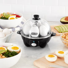 Load image into Gallery viewer, Lifestyle image of Dash Rapid Egg Cooker: 6 Egg Capacity Electric Egg Cooker.