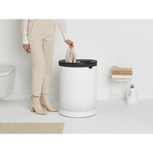 Load image into Gallery viewer, Lifestyle image of Brabantia Laundry Bin with Inner Removable Bag - 55 Liters, Selector - White.