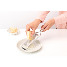Load image into Gallery viewer, Brabantia Profile Slice Grater - Matt Steel, in use.