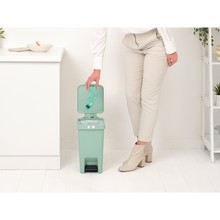 Load image into Gallery viewer, Lifestyle image of Brabantia StepUp Pedal Bin from Recycled Plastic - 10 Liters, Jade Green.