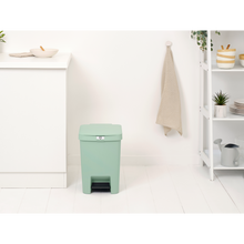 Load image into Gallery viewer, Lifestyle image of Brabantia StepUp Pedal Bin from Recycled Plastic - 25 Liters, Jade Green.