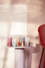 Load image into Gallery viewer, Lifestyle image of Bolsius Sunset Rustics Medium Pillar Candle, Misty Pink + Amber - 130/68mm.