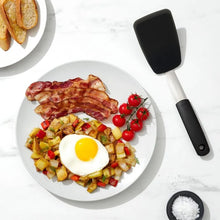 Load image into Gallery viewer, Lifestyle image of OXO Good Grips Small Silicone Flexible Turner - Black.
