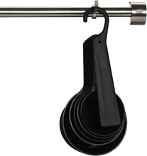 Load image into Gallery viewer, OXO Good Grips Set of 5 Measuring Cups + Scraper - Black, hanging.
