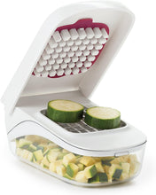 Load image into Gallery viewer, OXO Good Grips Vegetable Chopper with Easy Pour Feature - White, in use with zucchini.
