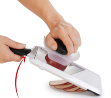 Load image into Gallery viewer, OXO Good Grips Adjustable Handheld Mandoline Slicer - White, in use with apple.
