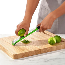 Load image into Gallery viewer, OXO Good Grips Etched Zester - Green, in use.
