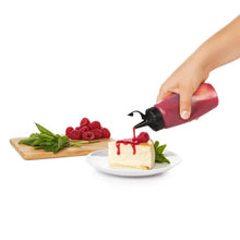 Load image into Gallery viewer, OXO Good Grips Chef&#39;s Squeeze Bottle - Available in 2 Sizes, in use.
