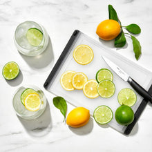 Load image into Gallery viewer, Lifestyle image of OXO Good Grips Prep Cutting Board - 18 x 27cm, Translucent White.

