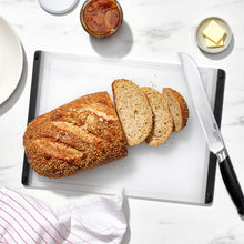 Load image into Gallery viewer, OXO Good Grips Utility Cutting Board - 26.75 x 37cm, Translucent White, lifestyle image.
