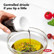 Load image into Gallery viewer, OXO Good Grips Precision Pour Glass Dispenser - 150ml, in use.
