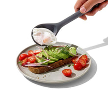 Load image into Gallery viewer, Lifestyle image of OXO Good Grips Silicone Slotted Spoon - Peppercorn.
