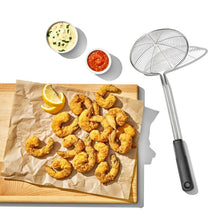 Load image into Gallery viewer, Lifestyle image of OXO Good Grips Scoop &amp; Strain Skimmer - Stainless Steel.
