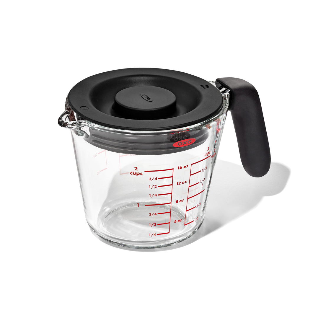 OXO Good Grips Glass Measuring Cup with Lid - 500ml, angled view.