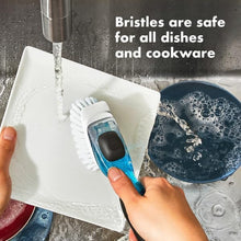 Load image into Gallery viewer, OXO Good Grips Soap Dispensing Dish Brush - Black/White, in use on plates.
