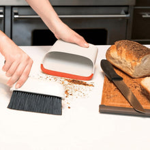 Load image into Gallery viewer, Lifestyle image of OXO Good Grips Compact Dust Pan &amp; Brush Set - White/ Black.
