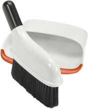 Load image into Gallery viewer, OXO Good Grips Compact Dust Pan &amp; Brush Set - White/ Black, in use.
