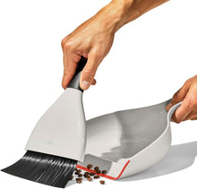 Load image into Gallery viewer, OXO Good Grips Dust Pan &amp; Brush Set - White/ Black, in use.
