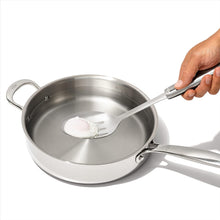 Load image into Gallery viewer, OXO Good Grips Slotted Cooking Spoon - Stainless Steel, in use.
