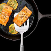 Load image into Gallery viewer, Lifestyle image of OXO Good Grips Cooking Turner - Stainless Steel.
