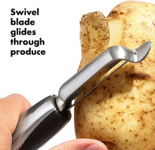 Load image into Gallery viewer, OXO Good Grips Swivel Peeler - Stainless Steel, in use.
