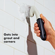 Load image into Gallery viewer, OXO Good Grips Grout Cleaning Brush - White, in use.

