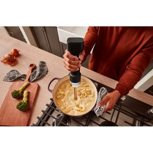 Load image into Gallery viewer, Lifestyle image of KitchenAid Go Cordless Hand Blender with Battery - Matt Black.
