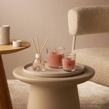 Load image into Gallery viewer, Lifestyle image of Bolsius True Scents Fragranced Candle in Glass - 97/85mm, Apple Cinnamon.
