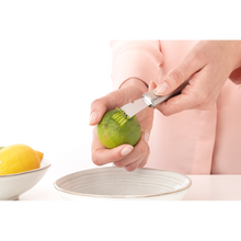 Load image into Gallery viewer, Brabantia Profile Lemon Zester - Matt Steel, lifestyle image of product in use.
