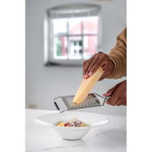 Load image into Gallery viewer, Lifestyle image of Brabantia Profile Slice Grater - Matt Steel, in use.
