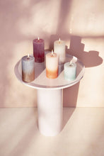 Load image into Gallery viewer, Lifestyle image of Bolsius Sunset Rustics Medium Pillar Candle, Misty Pink + Amber - 130/68mm.
